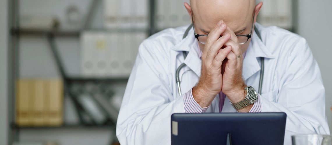 Puzzled doctor tired from work