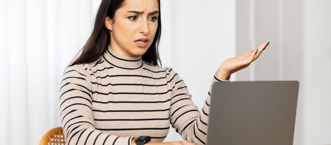 Sad confused woman manager work at computer, find mistake